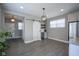 Modern dining room features wood floors, barn door, dry bar, and contemporary light fixture at 7228 Broadacre Ct, Carmel, IN 46033