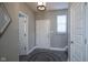 Inviting entryway with neutral paint, wood-look floors, and a stylish light fixture; great first impression at 7228 Broadacre Ct, Carmel, IN 46033