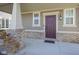 A well-maintained front door entrance features a brick pillar and a covered porch, enhancing the home's inviting exterior at 7228 Broadacre Ct, Carmel, IN 46033