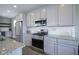 Close up of the kitchen with stainless steel appliances, granite countertops, and white subway tile at 7228 Broadacre Ct, Carmel, IN 46033