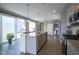 Kitchen with bar seating, granite countertops and stainless appliances leading to the outdoors at 7228 Broadacre Ct, Carmel, IN 46033