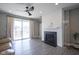 Living room with fireplace, modern ceiling fan and sliding glass doors to the backyard at 7228 Broadacre Ct, Carmel, IN 46033