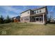Expansive backyard with a grassy lawn, patio, and a playset, ideal for outdoor enjoyment at 7239 Bellini Ln, Indianapolis, IN 46259