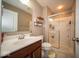 A clean, well-lit bathroom includes a shower, toilet, vanity, and storage space for all your needs at 7239 Bellini Ln, Indianapolis, IN 46259