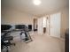 Neutral-toned bedroom featuring carpeted floors, a ceiling light, and a computer desk along one wall at 7239 Bellini Ln, Indianapolis, IN 46259