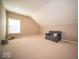 Large bonus room with a cozy sofa, neutral walls, and ample space for relaxation or recreation at 7239 Bellini Ln, Indianapolis, IN 46259