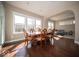 Bright dining room featuring hardwood floors, natural light, and an elegant dining set at 7239 Bellini Ln, Indianapolis, IN 46259