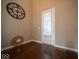 Bright entryway with hardwood floors, a stylish mirror, and a door with window at 7239 Bellini Ln, Indianapolis, IN 46259