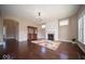 Open living room with hardwood floors, fireplace, large windows, and stylish decor at 7239 Bellini Ln, Indianapolis, IN 46259