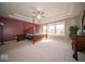 Spacious main bedroom with a four-poster bed, tray ceiling, and large windows providing natural light at 7239 Bellini Ln, Indianapolis, IN 46259