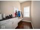 Practical mudroom with white cabinets, counter space, and a built-in bench and coat rack at 7239 Bellini Ln, Indianapolis, IN 46259