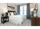 Bedroom with carpet, white walls, an ensuite bathroom, and modern decor at 7572 Bluegill Dr, Noblesville, IN 46062
