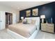 Primary bedroom featuring neutral carpet, blue accent wall, and access to ensuite bathroom at 7572 Bluegill Dr, Noblesville, IN 46062
