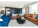 Well-lit living room with plush seating, a large decorative clock, and views to the backyard at 7572 Bluegill Dr, Noblesville, IN 46062