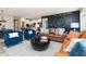 Inviting living room features a leather sofa, blue chairs, modern decor, and wood-look floors at 7572 Bluegill Dr, Noblesville, IN 46062