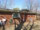 Brick home backyard featuring a fenced yard and mature trees, perfect for outdoor activities and privacy at 7625 Partridge Rd, Indianapolis, IN 46227