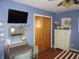 Cozy bedroom with decoratively painted walls, wood floors, and complemented by a ceiling fan and modern furniture at 7625 Partridge Rd, Indianapolis, IN 46227