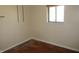 Unfurnished bedroom featuring hardwood floors, a window, and freshly painted walls at 7625 Partridge Rd, Indianapolis, IN 46227