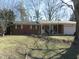 Charming one-story brick home with a covered porch and an attached garage, complemented by a well-maintained front lawn at 7625 Partridge Rd, Indianapolis, IN 46227