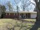 Charming one-story brick home with a covered porch and an attached garage, complemented by a well-maintained front lawn at 7625 Partridge Rd, Indianapolis, IN 46227