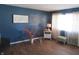 Inviting living room featuring a soothing blue accent wall, modern decor, and wood-look flooring at 7625 Partridge Rd, Indianapolis, IN 46227