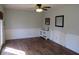 Bright room with a door to the exterior, complemented by wood-look flooring, and chair-rail detail at 7625 Partridge Rd, Indianapolis, IN 46227