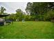 Lush backyard with a playhouse, shed, and trampoline offers ample space for outdoor enjoyment and recreation at 8172 Shottery Ter, Indianapolis, IN 46268