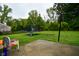 Spacious backyard featuring a trampoline, lush green lawn, and a basketball hoop for outdoor recreation at 8172 Shottery Ter, Indianapolis, IN 46268