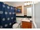 Bathroom featuring a floral shower curtain, toilet and vanity with cultured marble countertop at 8172 Shottery Ter, Indianapolis, IN 46268