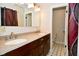 Bathroom featuring a double vanity sink with cultured marble countertop and dark cabinets at 8172 Shottery Ter, Indianapolis, IN 46268