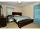 Relaxing bedroom with natural light, a comfortable bed, and a convenient bench at 8172 Shottery Ter, Indianapolis, IN 46268
