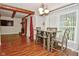 Dining area with wood-look flooring, connected to living room, featuring a table with seating for four at 8172 Shottery Ter, Indianapolis, IN 46268