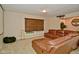 Comfortable living room featuring a brown leather sectional sofa and natural light at 8172 Shottery Ter, Indianapolis, IN 46268