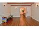 Versatile living area with wood-look flooring and access to the foyer, dining room, and hall at 8172 Shottery Ter, Indianapolis, IN 46268
