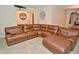 Spacious living room featuring a large brown leather sectional sofa and decor at 8172 Shottery Ter, Indianapolis, IN 46268