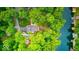 Aerial view of property featuring lush greenery, a lake view, and outdoor entertainment areas along a wooded hillside at 8205 Bass Dr, Nineveh, IN 46164