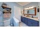 Stylish bathroom with double sink vanity, decorative shelves, and modern fixtures at 8205 Bass Dr, Nineveh, IN 46164