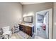 Bathroom featuring a double vanity sink and wood look tile flooring with an attached room at 8205 Bass Dr, Nineveh, IN 46164
