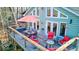 Spacious outdoor deck with seating, dining area and a decorative sun ornament at 8205 Bass Dr, Nineveh, IN 46164