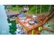 Multi-level dock with outdoor seating area, outdoor bar and watercraft lifts offers the ultimate lakeside experience at 8205 Bass Dr, Nineveh, IN 46164