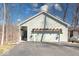 Home featuring a two-car garage with a trellis and hanging flower baskets above at 8205 Bass Dr, Nineveh, IN 46164