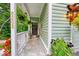 Charming covered front porch with attractive accents and beautiful plants and landscaping at 8205 Bass Dr, Nineveh, IN 46164