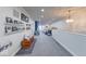 Spacious open living area with carpet, bright light fixture, and wall decorations at 8205 Bass Dr, Nineveh, IN 46164