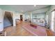 Large living area with hardwood floors, neutral paint, sofa, and staircase at 8205 Bass Dr, Nineveh, IN 46164