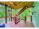 Staircase on outdoor deck with wood and cable railing overlooking wooded lake view with water visible underneath at 8205 Bass Dr, Nineveh, IN 46164