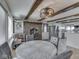 Inviting dining area featuring a wood-burning stove, wooden beams, and modern appliances at 8460 S Green Dr, Nineveh, IN 46164