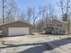 View of the home with a detached two car garage and a spacious gravel driveway at 8460 S Green Dr, Nineveh, IN 46164