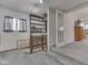 Hallway with gray carpet, natural light, and a built-in bookcase for added storage at 8460 S Green Dr, Nineveh, IN 46164