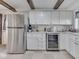 Kitchen with stainless steel refrigerator, white cabinets, and wine cooler at 8460 S Green Dr, Nineveh, IN 46164