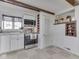 Kitchen features stainless steel appliances, white cabinets, and wood beams at 8460 S Green Dr, Nineveh, IN 46164